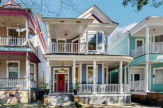 The colorful Victorian exterior of Ola's Oasis, a landmark Savannah, GA vacation rental home.