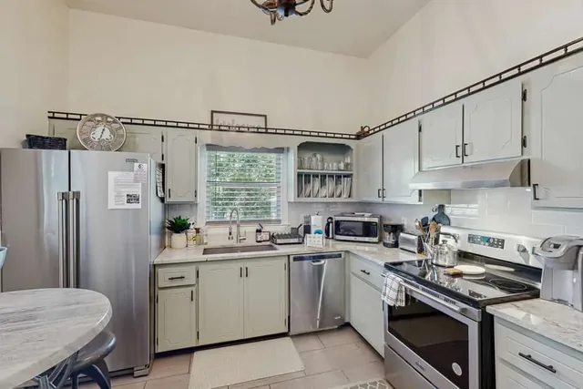 Bright, fully equipped kitchen with stainless steel appliances at Ola's Oasis, a whole-home vacation rental in Savannah, GA.