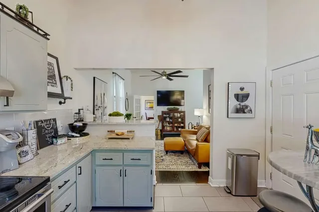 The full kitchen opens toward a cozy living area at Ola's Oasis, a whole-home vacation rental in Savannah, GA.