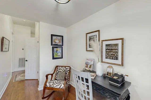 A vintage writing desk and antique typewriter set a nostalgic tone at Ola's Oasis, a Savannah, GA vacation rental.